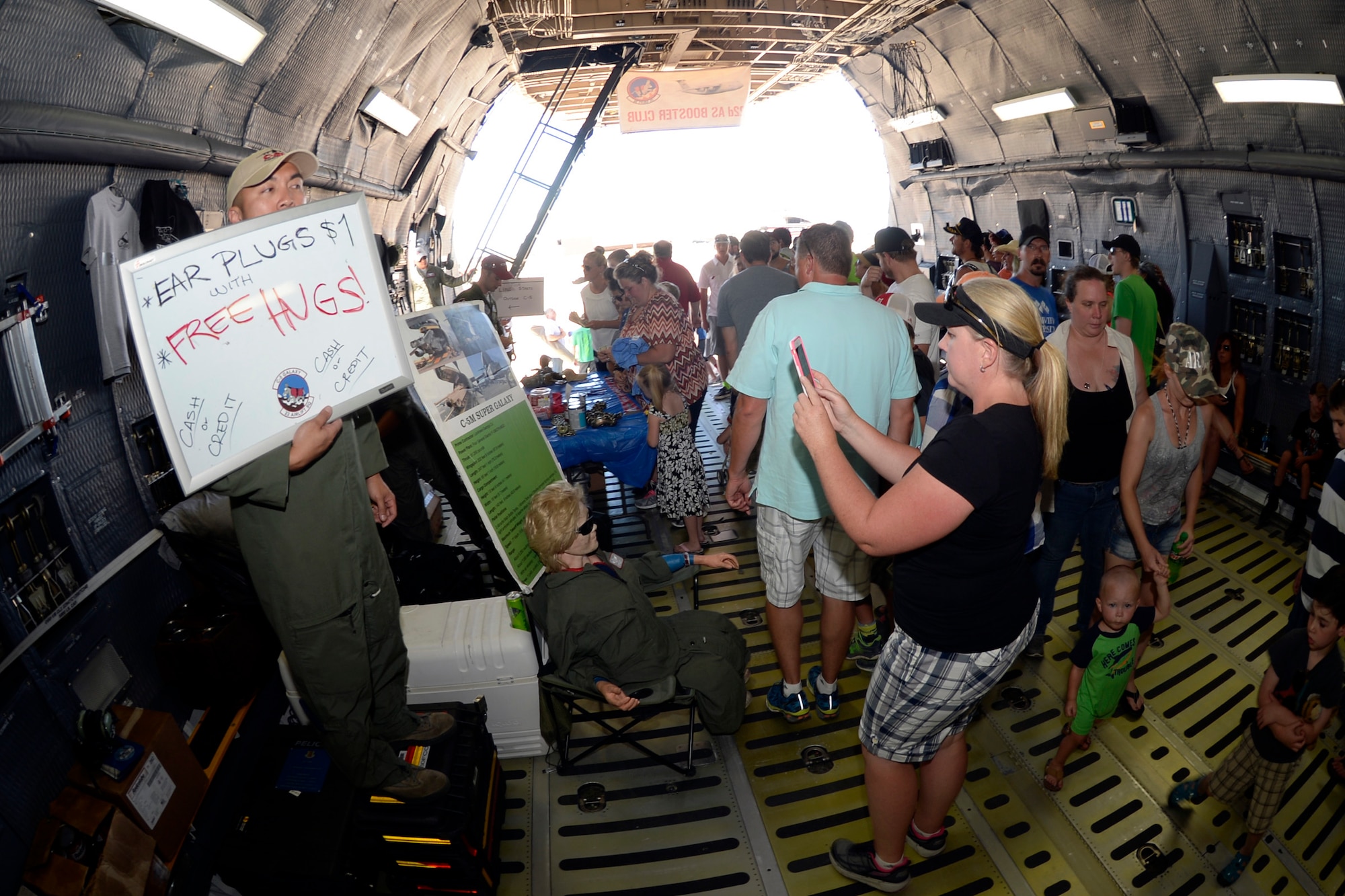 People walking through the belly of a cargo plane