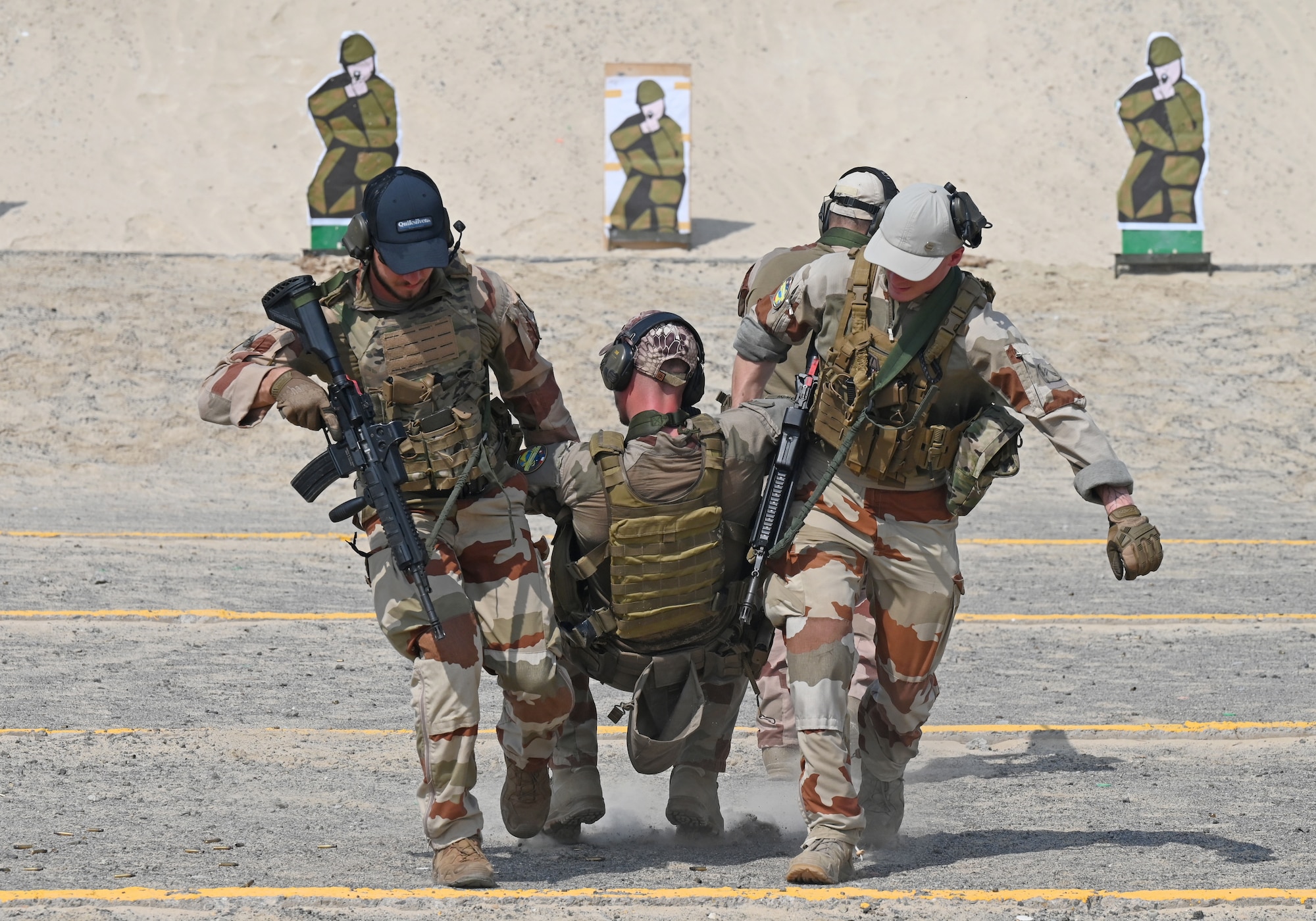 A photo of a man being carried by two people.