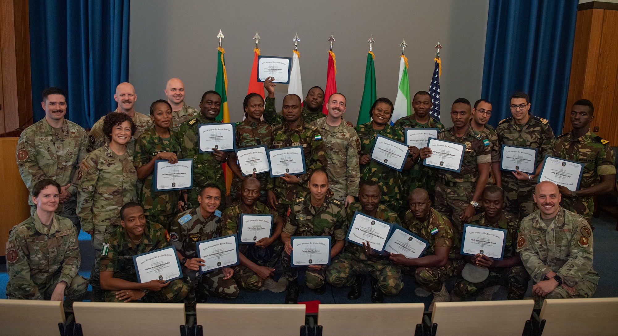 Members from the first all African Inter-African Professional Development Seminar gather with Inter-European Air Forces Academy team members for a group photo at the Kirk Theatre, Einsiedlerhof Air Station, Germany, July 21, 2023.