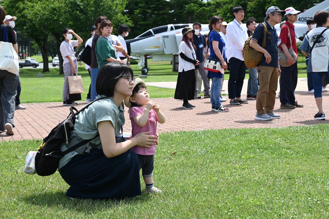 A mother and child participating in a Misawa Friendship Tour look at the different static displays located around Risner Circle at Misawa Air Base, Japan, July 14, 2023.