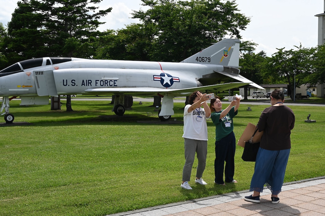 Participants of a Misawa Friendship Tour take a photo in front of the F-4C PHANTOM II static display at Risner circle on Misawa Air Base, Japan, July 14, 2023.