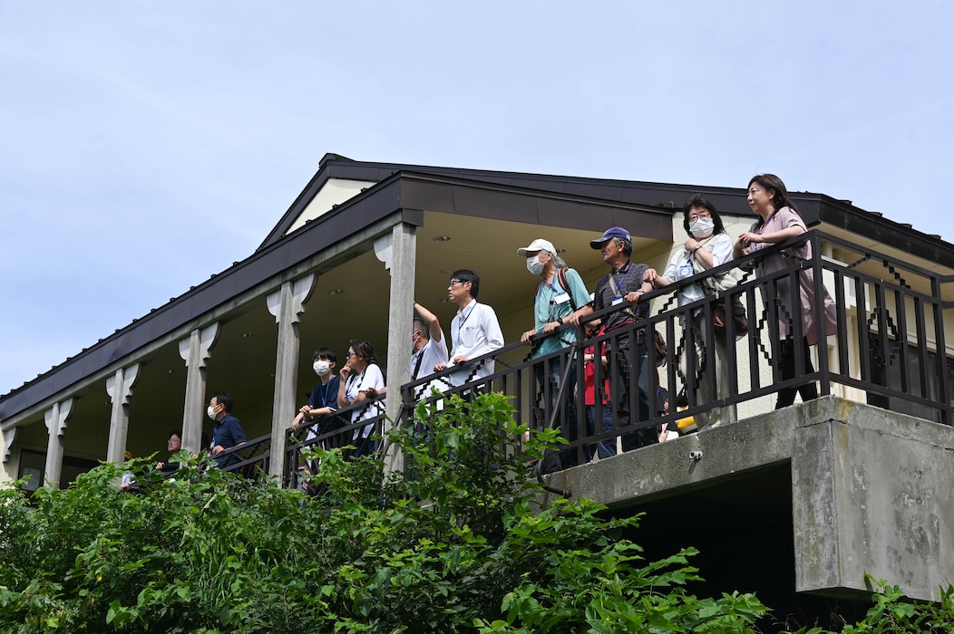 Participants of a Misawa Friendship Tour look out from the Lakeview Grille balcony at Misawa Air Base, Japan, July 14, 2023.