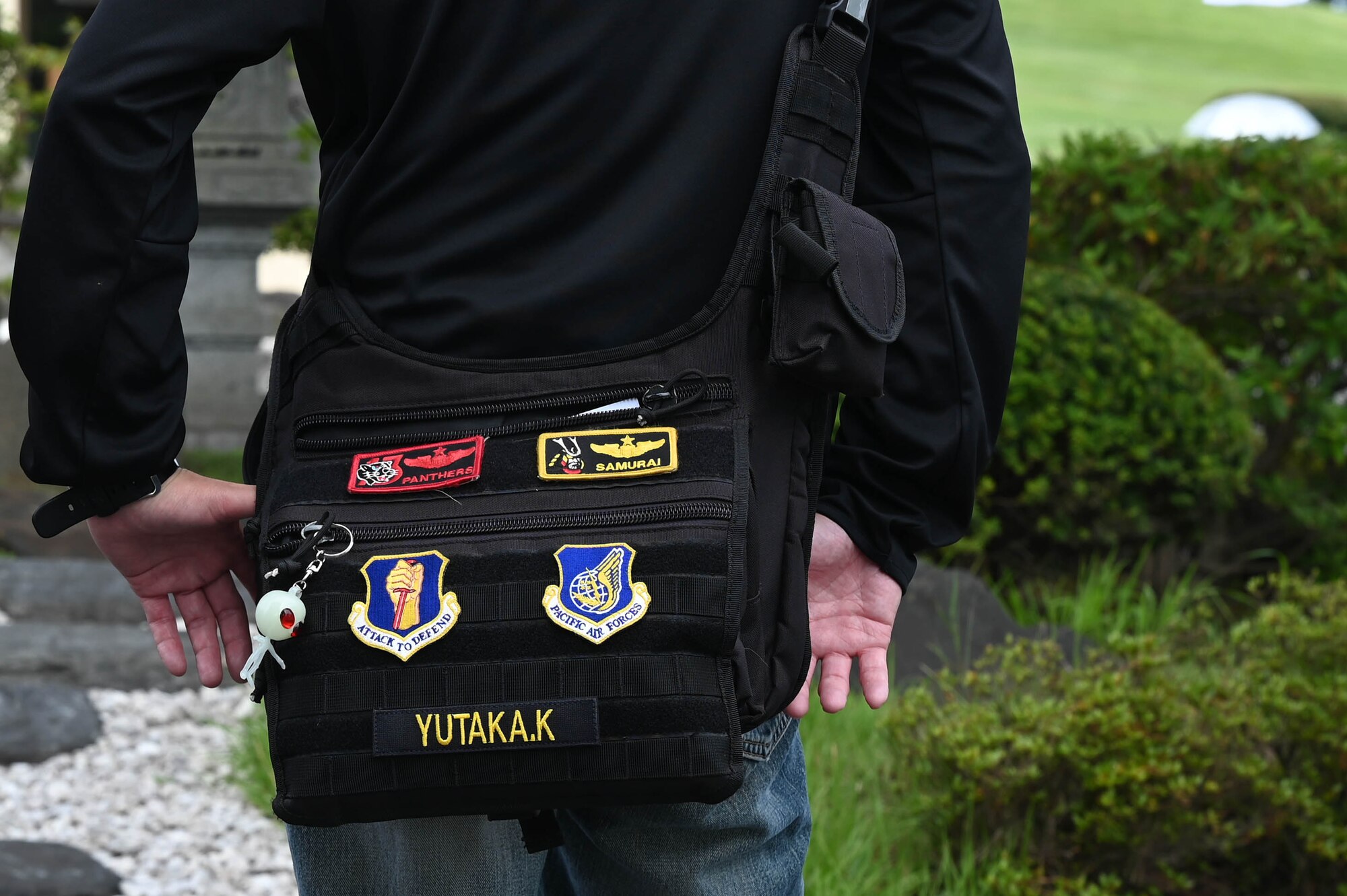 A participant of a Misawa Friendship Tour displays various Misawa patches on his bag at Misawa Air Base, Japan, July 14, 2023.