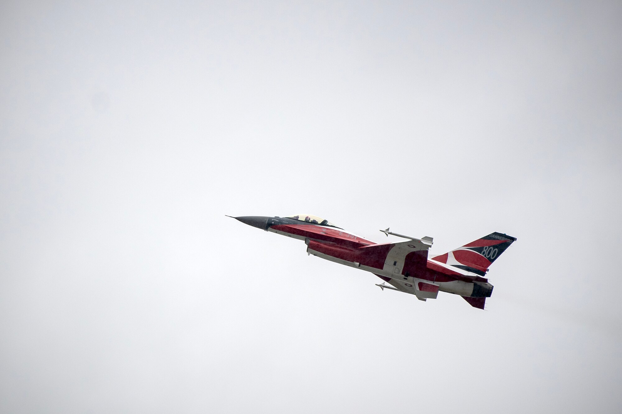 A Royal Danish Air Force F-16AM Fighting Falcon conducts an aerial demonstration during the 2023 Royal International Air Tattoo at RAF Fairford, England, July 14, 2023. Throughout RIAT, several nations exhibited their air power and capabilities for thousands of spectators helping inspire the next generation of aviation. (U.S. Air Force photo by Staff Sgt. Eugene Oliver)