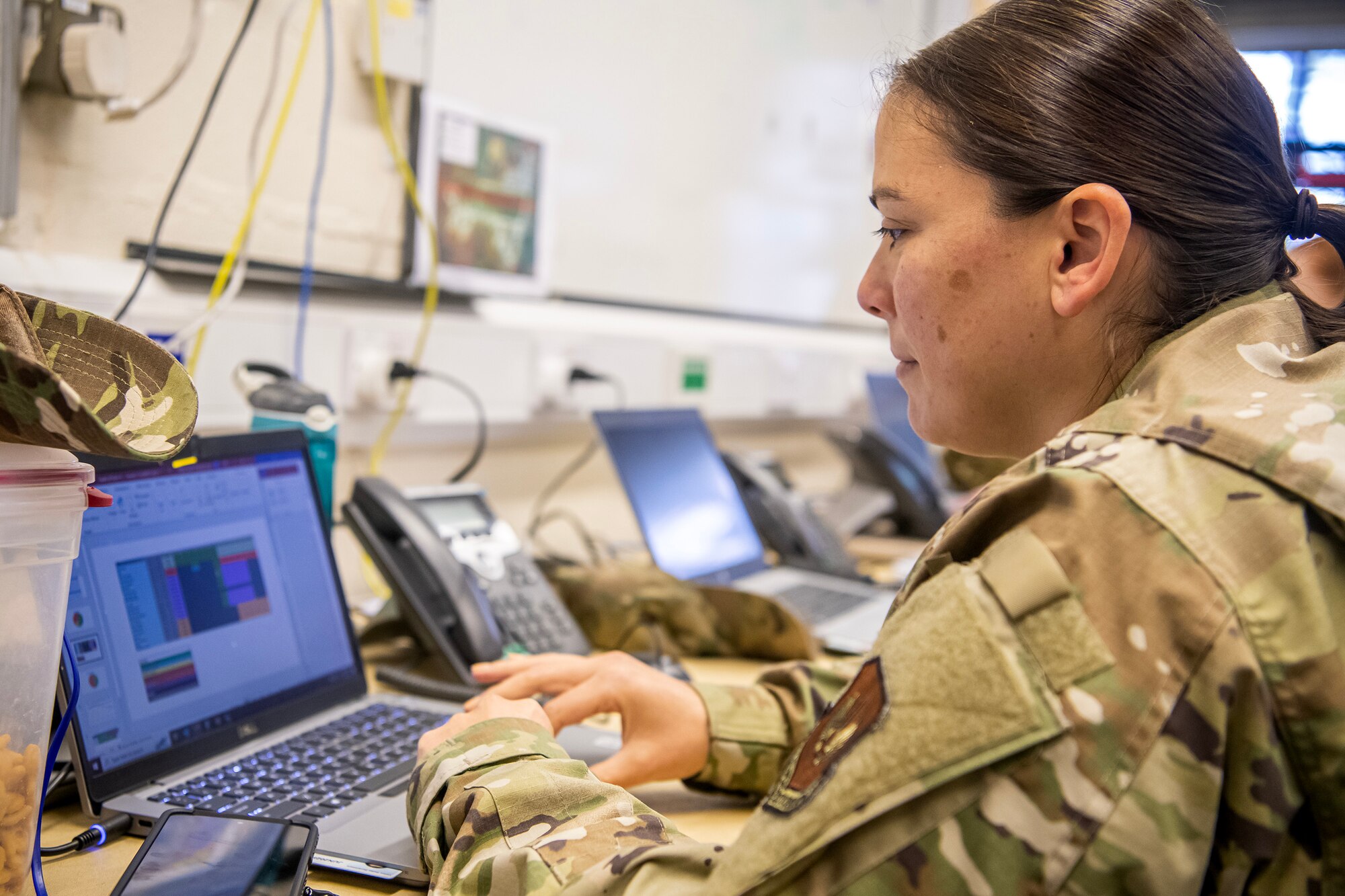 U.S. Air Force Master Sgt. Tania Robles, 422d Medical Squadron Medical Operations flight chief, provides Emergency Operations Center support during the 2023 Royal International Air Tattoo at RAF Fairford, England, July 15, 2023. Multiple Airmen deployed to and stationed at RAF Fairford provided security and emergency management services to ensure a successful air show. (U.S. Air Force photo by Staff Sgt. Eugene Oliver)