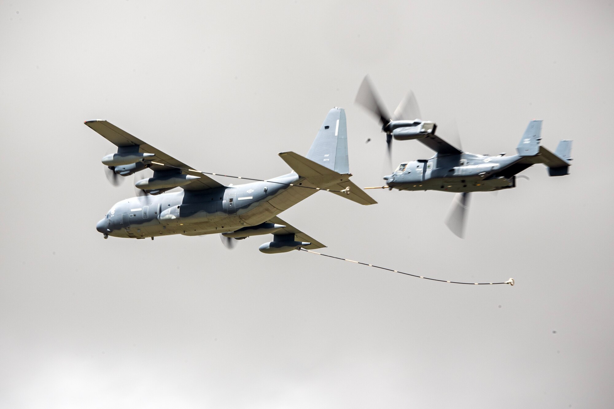 A CV-22B Osprey and MC-130J Commando II from RAF Mildenhall conduct an aerial refueling demonstration at the 2023 Royal International Air Tattoo, at RAF Fairford, England, July 15, 2023. RIAT participation demonstrates U.S. commitment to European allies and partners while highlighting U.S. capabilities to a diverse audience, emphasizing unity, innovation, and a shared commitment to excellence. (U.S. Air Force photo by Staff Sgt. Eugene Oliver)