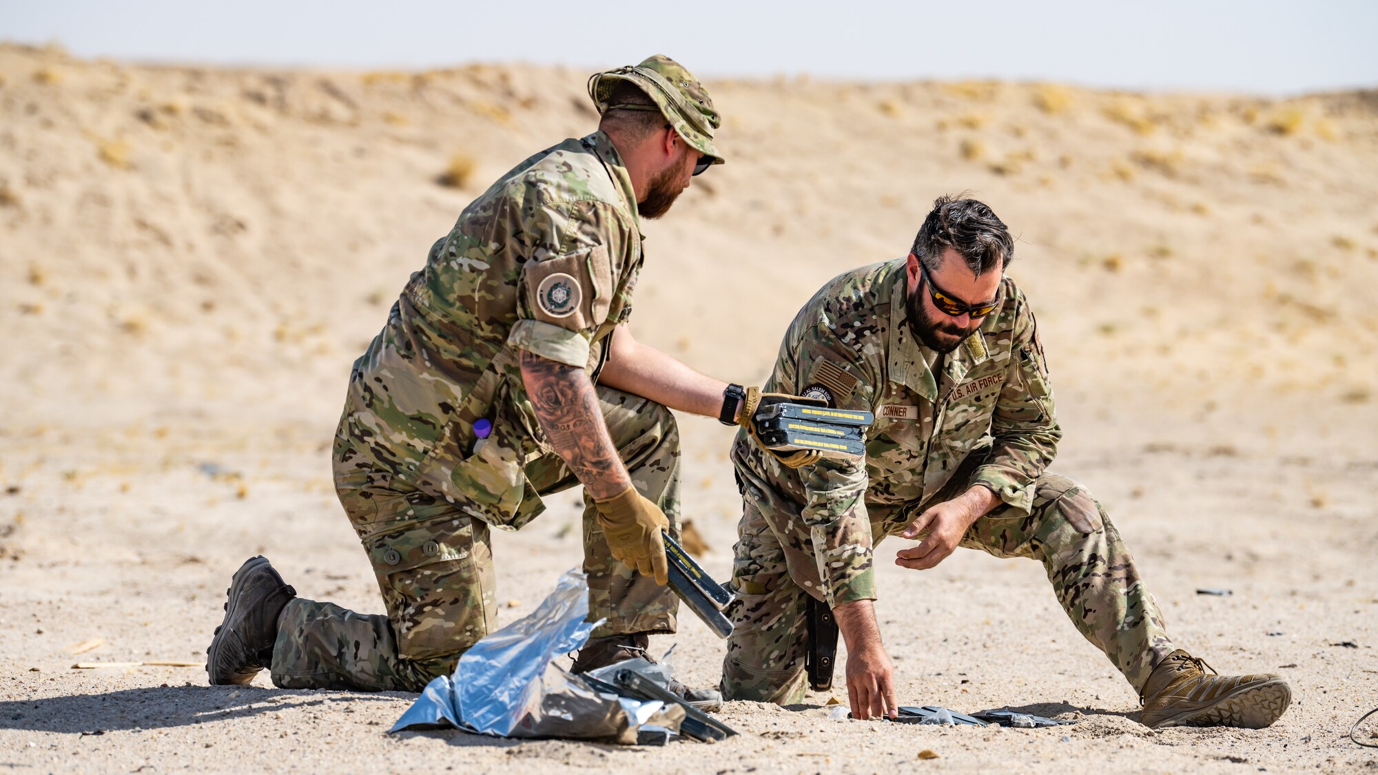 A U.S. Air Force explosive ordnance disposal (EOD) technician assigned to the 386th Expeditionary Civil Engineer Squadron lays out a detonation cord near Ali Al Salem Air Base, Kuwait, July 21, 2023. EOD technicians are experts in the safe handling and destruction of chemical, biological, incendiary, radiological and nuclear materials and devices, and they help ensure freedom of operations by removing such hazards. (U.S. Air Force photo by Staff Sgt. Kevin Long)