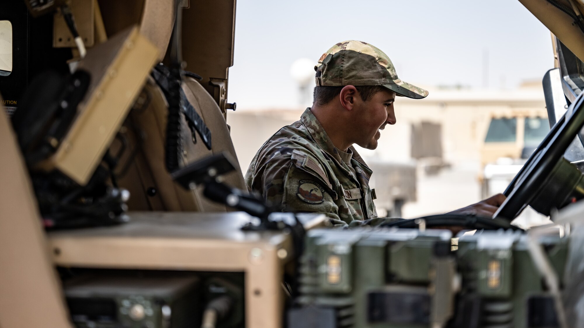 U.S. Air Force Staff Sgt. Bailey Paxson, 386th Expeditionary Security Forces Squadron vehicle control officer, talks to 386th ESFS military working dog handlers about the specs of Mine Resistant Ambush Protected All-Terrain Vehicle (M-ATV) during vehicle familiarity training at Ali Al Salem Air Base, Kuwait, July 13, 2023. The M-ATV is designed to provide the same levels of protection as the larger and heavier vehicles, but with enhanced mobility in the region’s rough terrain. (U.S. Air Force photo by Staff Sgt. Kevin Long)