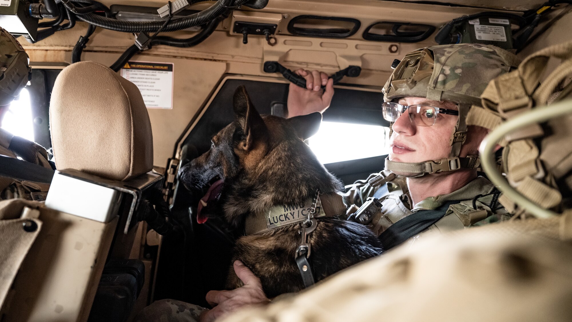 U.S. Air Force military working dog Lucky, left, and Staff Sgt. Kyle Dean, 386th Expeditionary Security Forces Squadron MWD handler, take a ride inside a Mine Resistant Ambush Protected All-Terrain Vehicle (M-ATV) during vehicle familiarity training at Ali Al Salem Air Base, Kuwait, July 13, 2023. The M-ATV is designed to provide the same levels of protection as the larger and heavier vehicles, but with enhanced mobility in the region’s rough terrain. (U.S. Air Force photo by Staff Sgt. Kevin Long)
