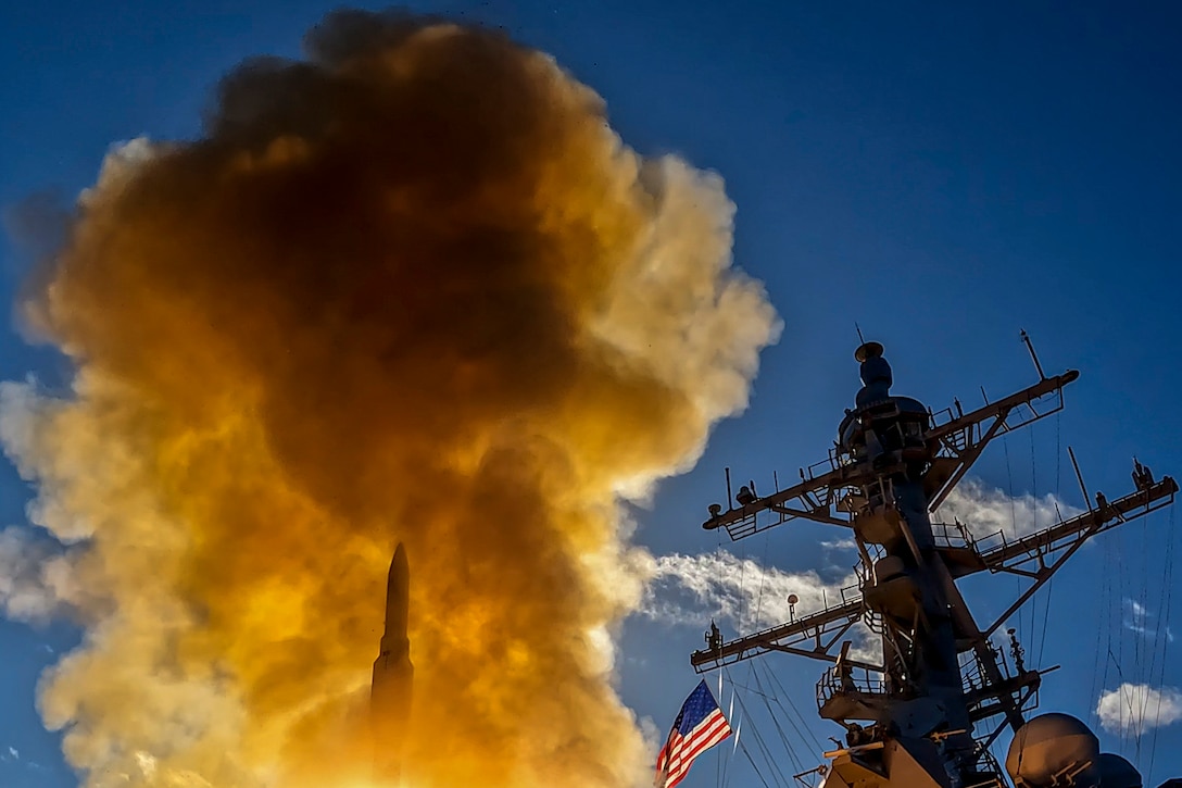 Smoke fills the air after a missile launches from a ship.