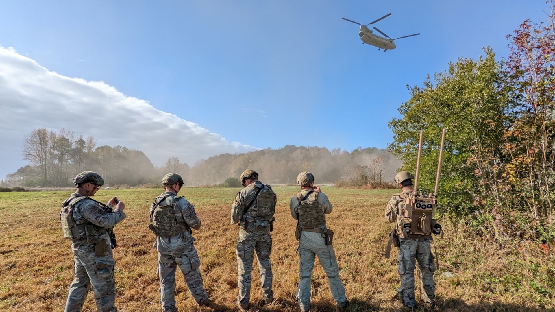 Airmen at Joint Base Langley Eustis, Virginia perform field exercises during Force Protection Operational Rehearsal (FPOR). An Airman (right) carries the dismounted “manpack” JCREW system to show capabilities during the event in November of 2022.