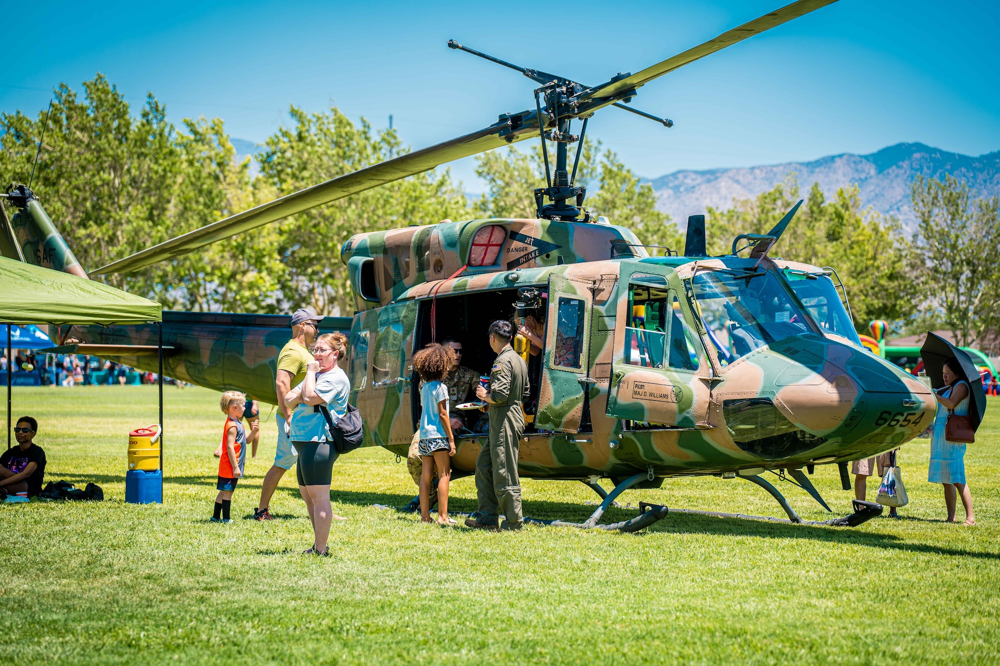 People stand around helicopter.