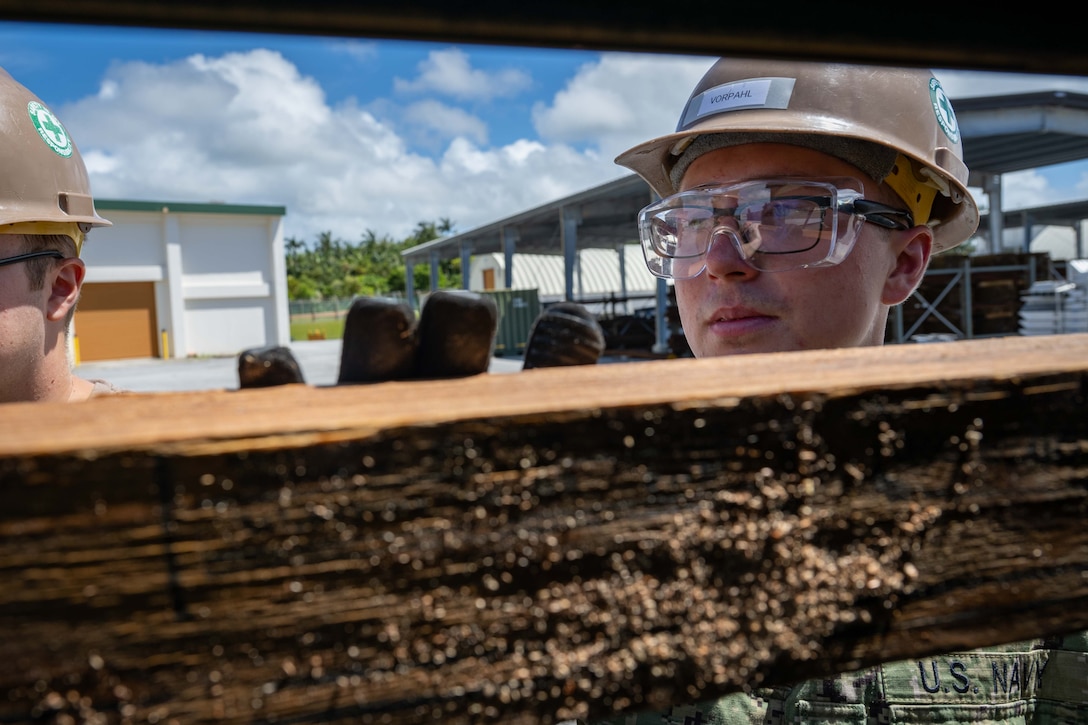 Builder Constructionman Bradley Vorphail, assigned to Naval Mobile Construction Battalion (NMCB) 3, applies shoring to a High Mobility Multipurpose Wheeled Vehicle (HMMWV) to assist in measurements during Mount Out Exercise training, onboard Camp Shields, Okinawa, July 15th.