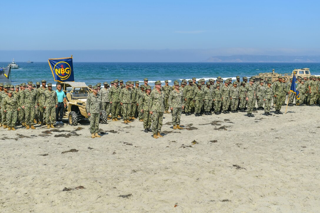 Sailors from Naval Beach Group One stand at attention for a group photo in honor of the 75th anniversary of NBG 1.