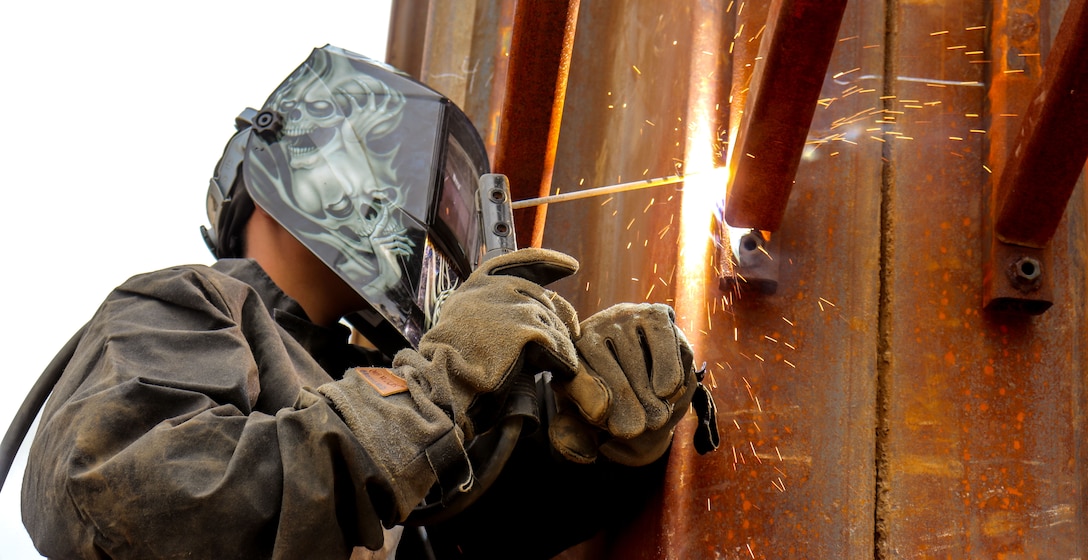 Port Hueneme, Calif. (July 21, 2023) Steelworker Second Class Cordelia Broussard, assigned to Naval Mobile Construction Battalion (NMCB) 4, welds brackets to metal sheet piles for the Construction Training Exercise (CTX) Quay Wall Pile Cap Project. NMCB 4 is implementing a robust construction skill training plan to prepare for a dynamic mission set throughout the US Indo-Pacific Command in support of Commander, 7th Fleet objectives.