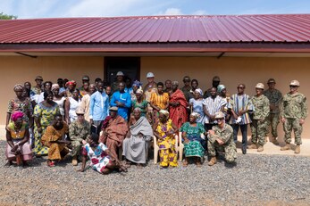 Village residents and Seabees assigned to Naval Mobile Construction Battalion (NMCB) 1 pose for a group photo during the commissioning of the Nutekpor District Assembly Basic School Nutekpor, Ghana, July 14, 2023.