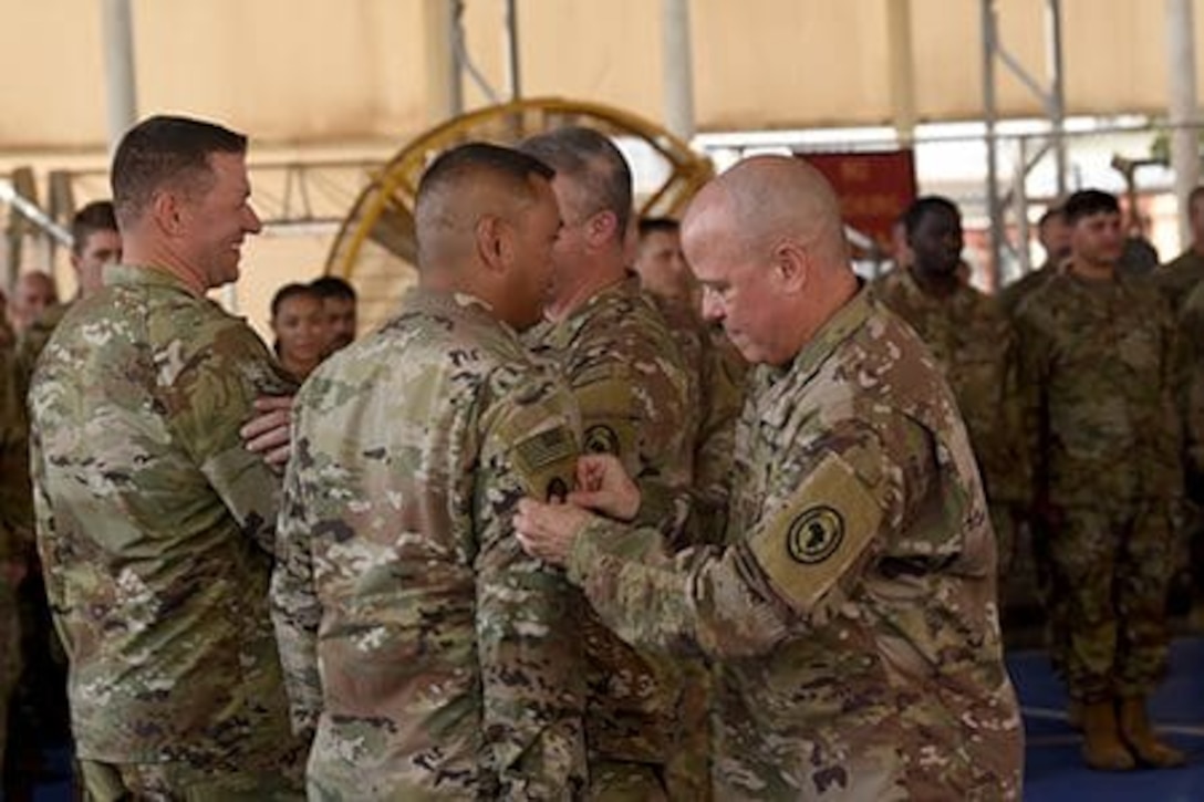 Wisconsin National Guard Soldiers assigned to Combined Joint Task Force-Horn of Africa are presented with the U.S. Africa Command combat patch during a ceremony at Camp Lemonnier, Djibouti, Dec. 30, 2022. The combat patch, worn on the right shoulder, distinguishes Soldiers who have deployed to a combat zone. Combined Joint Task Force-Horn of Africa. Photo by Sgt. 1st Class Katie Theusch.