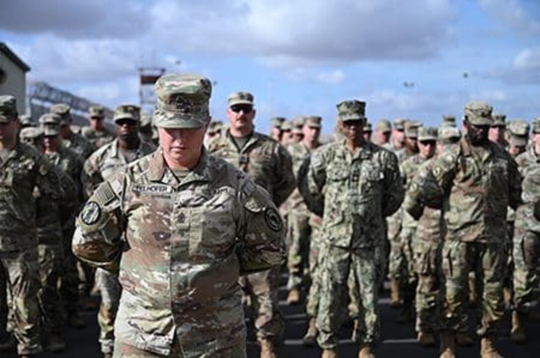 1st Sgt. Ann Felhofer, Combined Joint Task Force-Horn of Africa Headquarters Support Company senior enlisted leader, stands in front of a formation during Memorial Day ceremony at Camp Lemonnier, Djibouti, May 29. Felhofer is part of the Wisconsin Army National Guard's 157th Maneuver Enhancement Brigade headquarters' element, which is deployed in support of Combined Joint Task Force-Horn of Africa. U.S. Air National Guard. Photo by Tech. Sgt. Phuong Au.