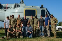 Airmen from the 5th Civil Engineer Squadron pose for a group picture at Minot Air Force Base, North Dakota, July 20, 2023. Senior Airman Anthony McCray, 5th CES pavements and construction equipment, describes their work for the project as “getting it all together where it needs to be”. (Air Force photo by Airman 1st Class Alyssa Bankston)