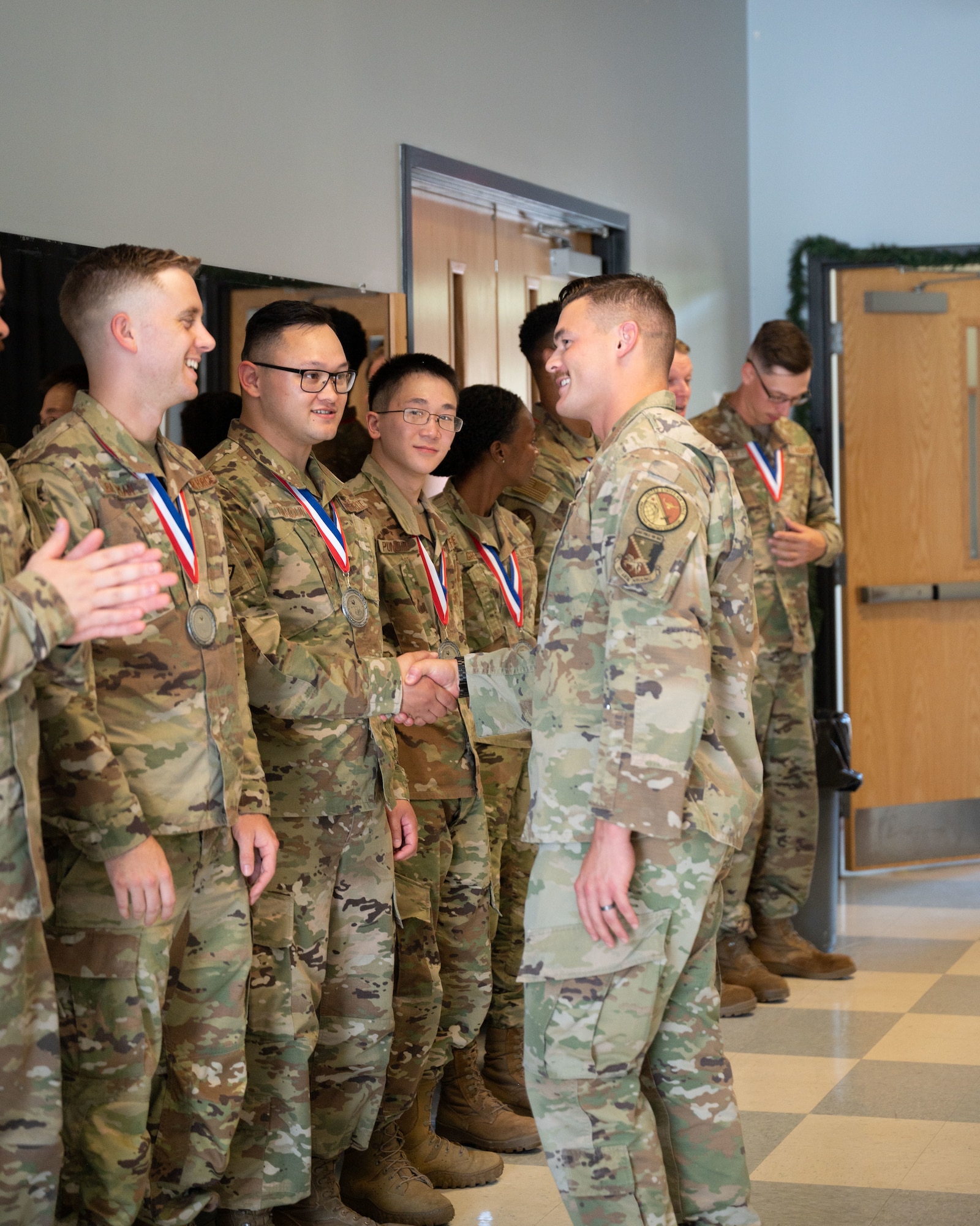 Staff Sgt. Austin Thoreen, the instructor for class 23-E1 from the 22nd Force Support Squadron, congratulates graduates at the Airman Leadership School gratuation July 20, 2023 at Pease Air National Guard Base, New Hampshire. This was the first in-person ALS at Pease hosted by the 157th Air Refueling Wing. (U.S. Air National Guard photo by Tech. Sgt. Victoria Nelson)