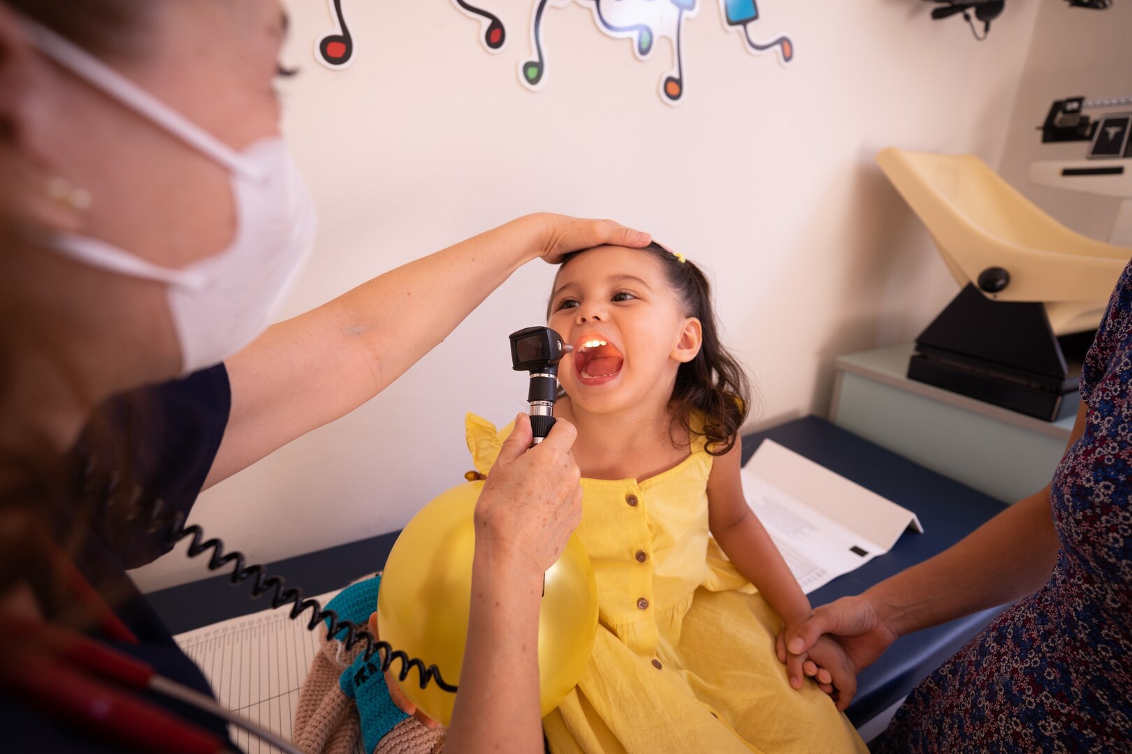 A young girl gets a checkup from the doctor