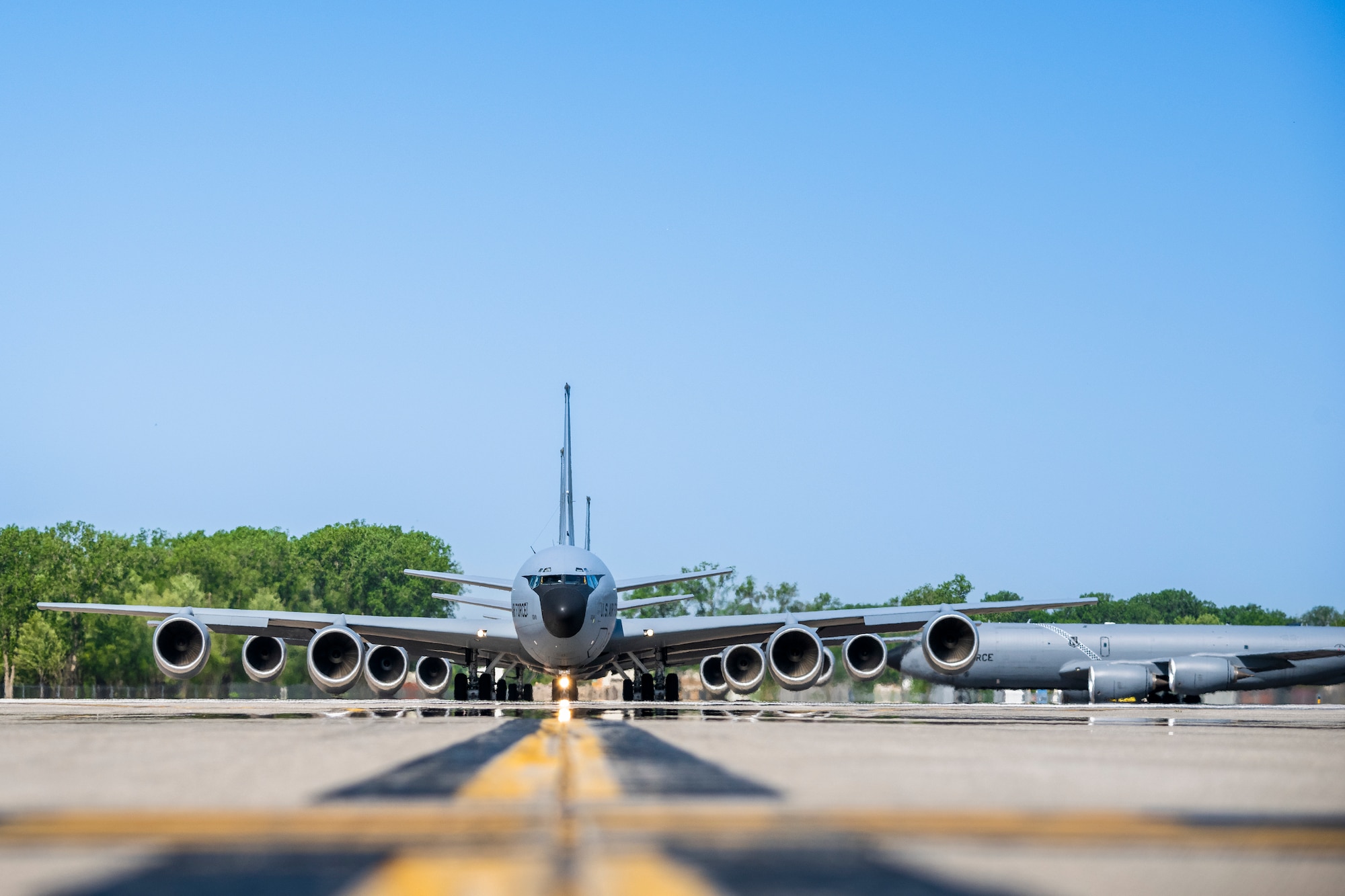 Line of KC135 aircraft on runway.