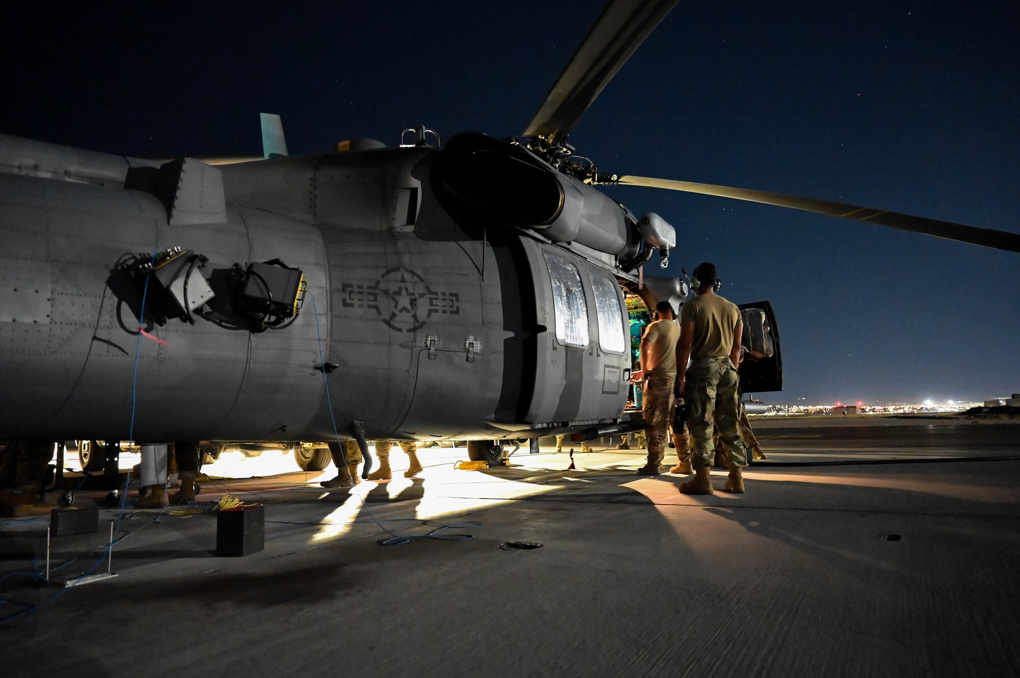 Airmen from the 87th Electronic Warfare Squadron assess the electronic warfare sensors of an HH-60G Pavehawk as part of COMBAT SHIELD during Red Flag 23-3 at Nellis Air Force Base, Nev., July 13, 2023. This Red Flag concentrated on three primary themes: defensive counter-air, offensive counter-air suppression of enemy air defenses, and offensive counter air-air interdiction. (U.S. Air Force photo by Capt. Benjamin Aronson)