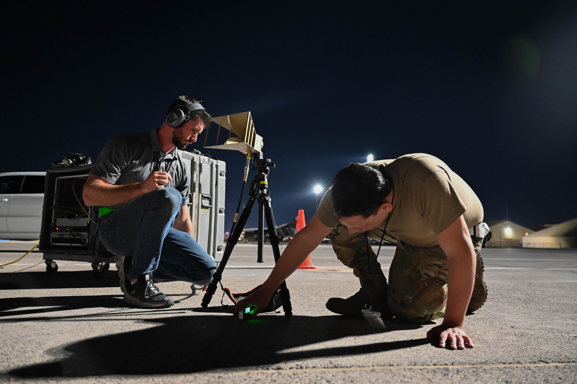 Corey Gaither, 87th Electronic Warfare Squadron COMBAT SHIELD avionics electronic warfare technician, left, and U.S. Air Force Senior Airman Eric Johnson, 87th EWS COMBAT SHIELD avionics electronic warfare journeyman, right, set up a horn agent during a COMBAT SHIELD assessment of aircraft during Red Flag 23-3 at Nellis Air Force Base, Nev., July 14, 2023. The device is used for transmitting radio frequencies that are received and analyzed by the electronic warfare system inside an aircraft. (U.S. Air Force photo by Capt. Benjamin Aronson)