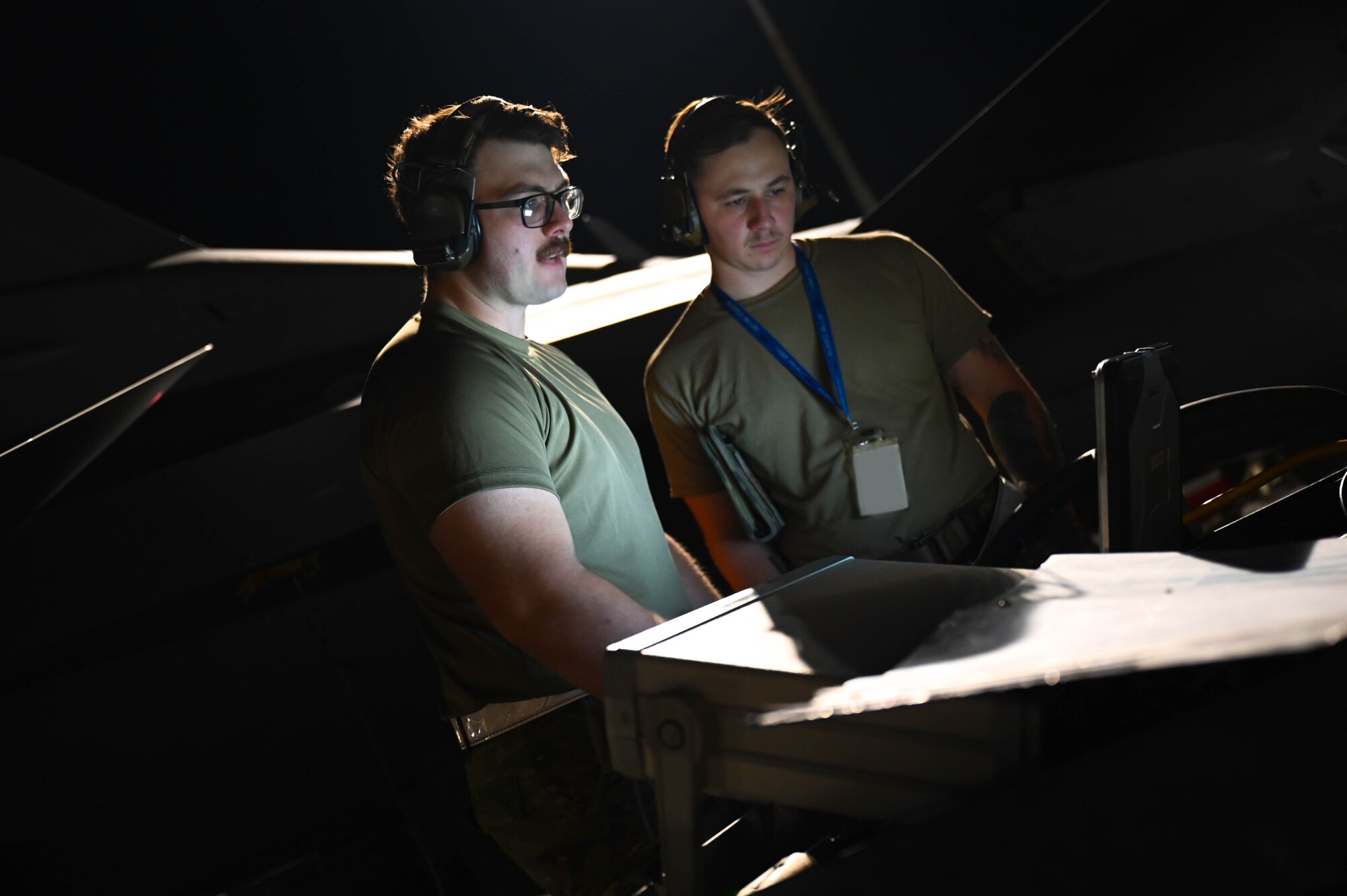 U.S. Air Force Staff Sgt. Daniel Rosser, 87th Electronic Warfare Squadron COMBAT SHIELD avionics electronic warfare journeyman, left, and U.S. Air Force William Staff Sgt. William Price, 87th EWS COMBAT SHIELD avionics electronic warfare journeyman, right, evaluate results from an electronic warfare assessment at Nellis Air Force Base, Nev., July 14, 2023. COMBAT SHIELD was conducted during Red Flag 23-3 as part of a required assessment of the Combat Air Force’s platforms. (U.S. Air Force photo by Capt. Benjamin Aronson)