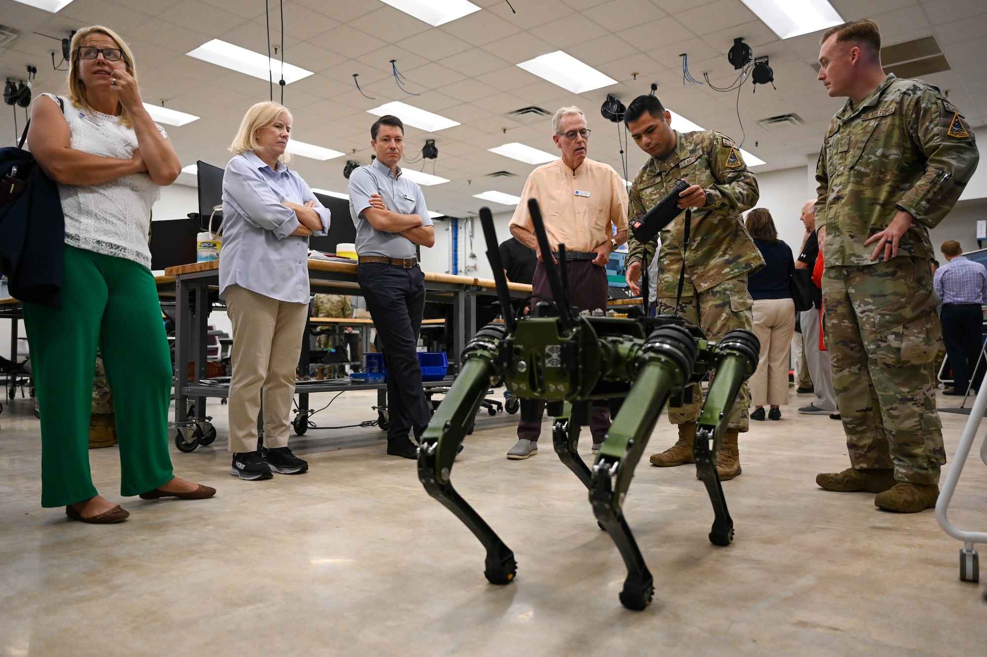 U.S. Air Force Senior Airman Emerson Papaia, 45 Security Forces Squadron strategic communications explaining how to operate a Ghost Robotics Quadruped Unmanned Ground Vehicle (Q-UGV) to a group of civic leaders at Patrick Space Force Base, Florida, July 20, 2023. The Air and Space Forces civic leaders are unpaid advisors, key communicators, and advocates for Department of the Air Force issues. (U.S. Space Force photo by Senior Airman Samuel Becker)