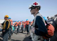 RED SEA (May 7, 2023) Hospital Corpsman 2nd Class Travis E. Billow, right, stands watch aboard guided-missile destroyer USS Arleigh Burke (DDG 51) during a replenishment-at-sea with dry cargo and ammunition ship USNS Alan Shepard (T-AKE 3), May 7, 2023, in the Red Sea. Arleigh Burke is deployed to the U.S. 5th Fleet area of operations to help ensure maritime security and stability in the Middle East region. (U.S. Navy photo by Mass Communication Specialist 2nd Class Almagissel Schuring) 230507-N-DE439-1052