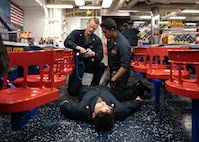 ATLANTIC OCEAN (April 25, 2023) Hospital Corpsman 2nd Class Travis E. Billow, left, trains Gunner’s Mate 2nd Class Angel Alamilla how to place a tourniquet on a patient during a Tactical Combat Casualty Care (TCCC) course aboard the Arleigh Burke-class guided-missile destroyer USS Arleigh Burke (DDG 51) during freshwater washdown, April 25, 2023. Arleigh Burke is on a scheduled deployment in the U.S. Naval Forces Europe area of operations, employed by U.S. Sixth Fleet to defend U.S., allied and partner interests. (U.S. Navy photo by Mass Communication Specialist 2nd Class Almagissel Schuring) 230425-N-DE439-1082
