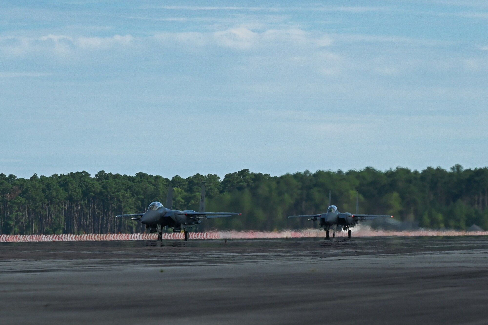 Two F-15E Strike Eagles taxi after landing at Marine Corps Air Station Cherry Point, North Carolina, in support of Razor Talon 2023, July 24, 2023. RT-23 is an agile combat employment focused exercise, designed to test the 4th Fighter Wing’s ability to operate as a lead wing to generate combat airpower while continuing to move, maneuver, sustain the wing and subordinate force elements in a dynamic contested environment. (U.S. Air Force photo by (U.S. Air Force photo by Airman 1st Class Leighton Lucero)