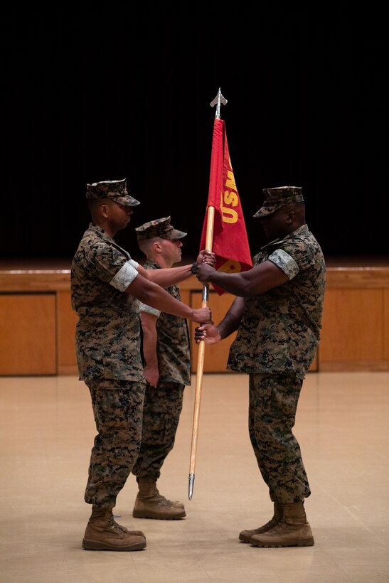 U.S. Marine Corps Maj. Phillip Tate, outgoing Bravo Company commander, Headquarters and Support Battalion, Marine Corps Installations Pacific, receives the company guidon from 1st Sgt. Shawn Bowman, B Co first sergeant, during a change of command ceremony for B Co, H&S Bn, MCIPAC, on Camp Foster, Okinawa, Japan, July 14, 2023. Tate served one year as the company commander for B Co, H&S Bn, MCIPAC, and was relieved by Capt. Matthew Mogish, a judge advocate with the Legal Services Support Section, MCIPAC. Tate will report as the new operations officer of S-3, Operations. (U.S. Marine Corps photo by Cpl. Thomas Sheng)