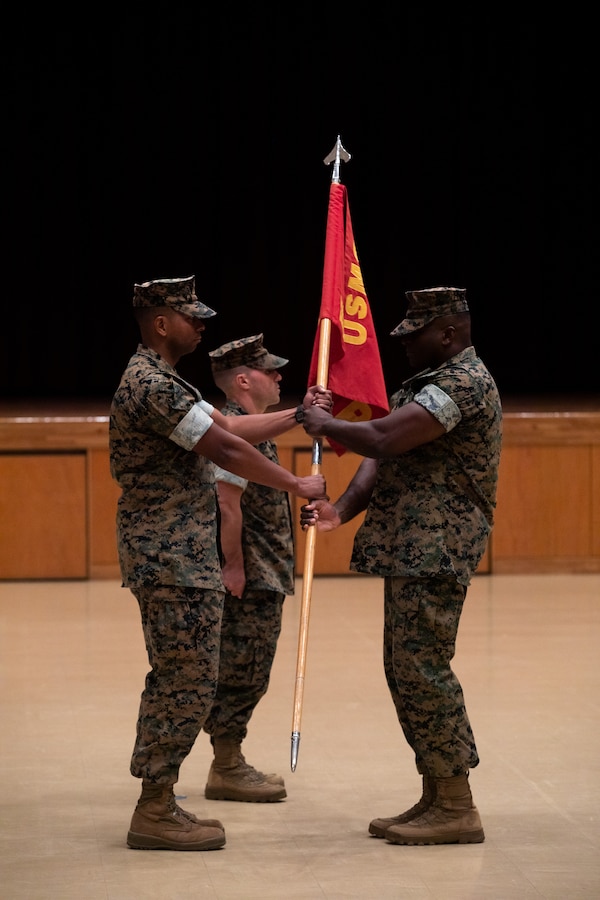 U.S. Marine Corps Maj. Phillip Tate, outgoing Bravo Company commander, Headquarters and Support Battalion, Marine Corps Installations Pacific, receives the company guidon from 1st Sgt. Shawn Bowman, B Co first sergeant, during a change of command ceremony for B Co, H&S Bn, MCIPAC, on Camp Foster, Okinawa, Japan, July 14, 2023. Tate served one year as the company commander for B Co, H&S Bn, MCIPAC, and was relieved by Capt. Matthew Mogish, a judge advocate with the Legal Services Support Section, MCIPAC. Tate will report as the new operations officer of S-3, Operations. (U.S. Marine Corps photo by Cpl. Thomas Sheng)