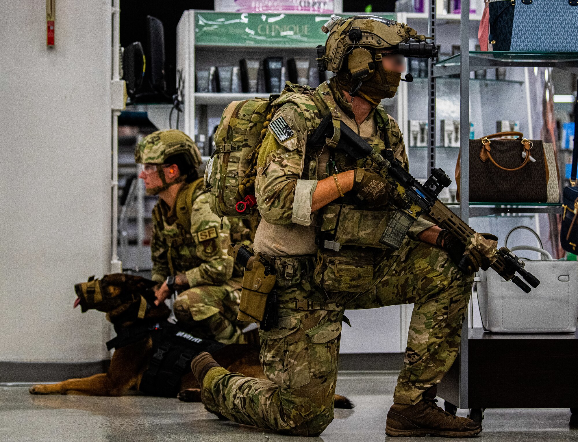 An Airman and Green Beret secure an area.