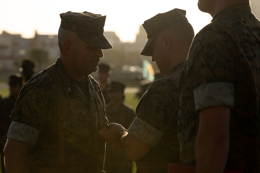 U.S. Marine Corps Col. Christopher M. Haar, the outgoing commanding officer of Combat Logistics Regiment 3, is presented the Legion of Merit, given for exceptionally meritorious conduct in the performance of outstanding services and achievements, by Brig. Gen. Adam L. Chalkley, the commanding general of 3rd Marine Logistics Group, center, during a change of command ceremony at Camp Foster, Okinawa, Japan, June 28, 2023. Marines and Sailors with CLR-3 celebrated Col. Christopher M. Haar’s successful years commanding the unit and welcome the incoming commander, Col. Jason B. Berg. (U.S. Marine Corps photo by Cpl. Alpha Hernandez)