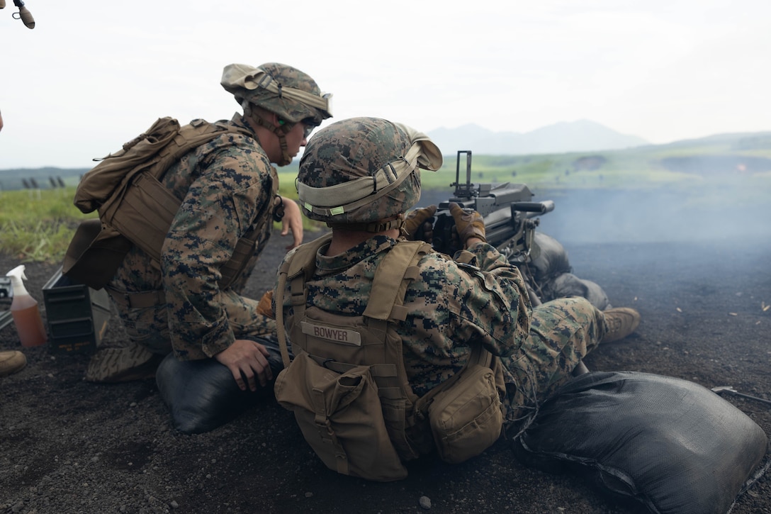 U.S. Marine Corps Lance Cpl. Ryan Delchambre, left, and PFC. Tai Bowyer, both landing support specialists with Combat Logistics Battalion 4, fire an MK19 grenade launcher during a live fire range on Combined Arms Training Center Fuji, June 29, 2023. CLB-4 conducted a live fire range to foster force readiness and condition warfighting skills. (U.S. Marine Corps photo by Lance Cpl. Federico Marquez)