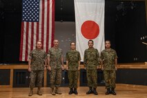 U.S. Marine Corps and Japanese Ground Self-Defense Force leadership pose for a photo during an opening ceremony for exercise Resolute Dragon 23 at Camp Kinser, Okinawa, Japan, July 9, 2023. Resolute Dragon 23 is an annual exercise for the III Marine Expeditionary Force, designed to strengthen the defensive capabilities of the U.S.-Japan alliance by demonstrating integrated command and control, targeting, combined arms, and maneuver across multiple domains, as part of the Stand-in-Force. (U.S. Marine Corps photo by Cpl. Sydni Jessee)