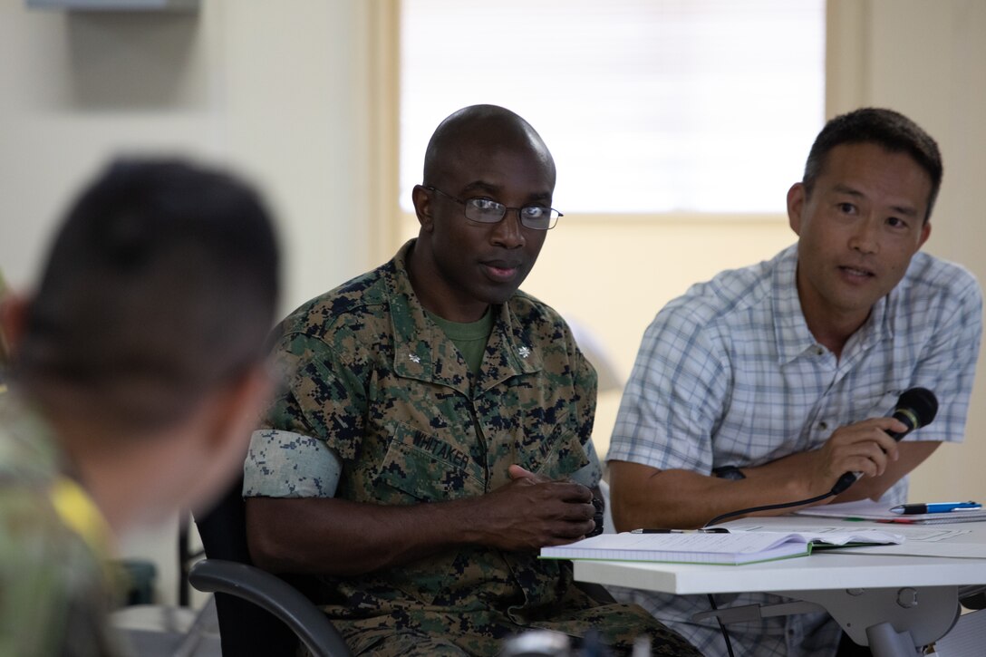 U.S. Marine Corps Lt. Col. Terry Whitaker, the bilateral ground logistics coordination center officer in charge, with Combat Logistics Regiment 37 Headquarters Company, talks with the Japan Ground Self Defense Force during the 3rd Marine Logistics Group and JGSDF Resolute Dragon 23 Command Post Exercise at Camp Kinser, Okinawa, Japan on 11 July, 2023. Resolute Dragon 23 is an annual exercise for the III Marine Expeditionary Force, designed to strengthen the defensive capabilities of the U.S.-Japan alliance by demonstrating integrated command and control, targeting, combined arms, and maneuver across multiple domains, as part of the Stand-in-Force. (U.S. Marine Corps photo by Cpl. Hunter Barber)