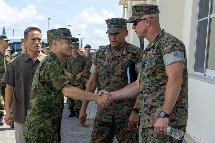 U.S. Marine Corps Col. Adam Romnek, right, the company commander for 3rd Maintenance Battalion, greets Lt. Gen Kizuki Ushijima, the ground material control commanding general for the Japan Ground Self Defense Force during Exercise Resolute Dragon 23 on Camp Kinser, Okinawa, Japan, July 12, 2023. Resolute Dragon 23 is an annual exercise the III Marine Expeditionary Force participates in, designed to strengthen the defensive capabilities of the U.S.-Japan alliance by demonstrating integrated command and control, targeting, combined arms, and maneuver across multiple domains, as part of the Stand-in-Force. (U.S. Marine Corps photo by Lance Cpl Federico Marquez)