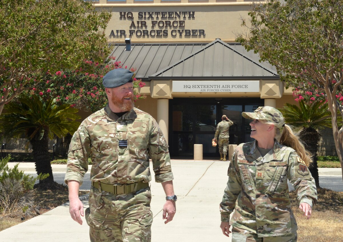 A photo of two military members walking.