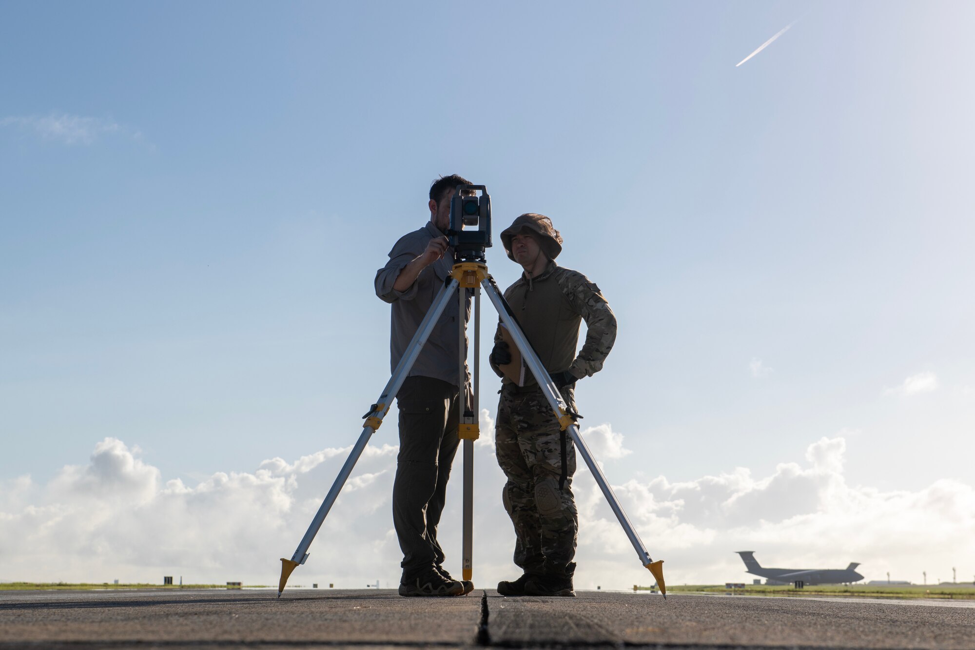 Airmen alongside ANPC engineer writing down height and distance of a landing system