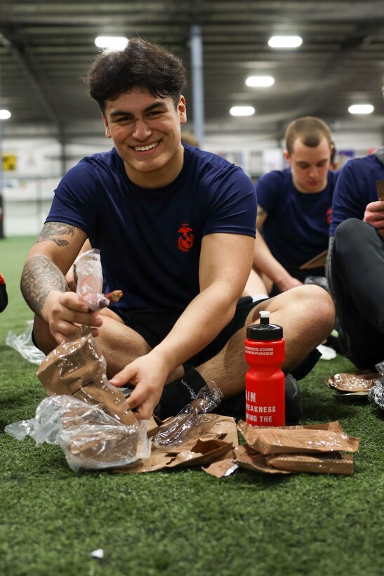 A poolee with Recruiting Station Cleveland, 4th Marine Corps District, preps and meal-ready-to-eat during an annual pool function in Rossford, Ohio, March 18, 2023. The annual pool function serves as an opportunity to build teamwork and camaraderie, and it serves as an event for potential future Marines to get first hand experience on drill instructors. (U.S. Marine Corps photo by Cpl. Austin Molla)