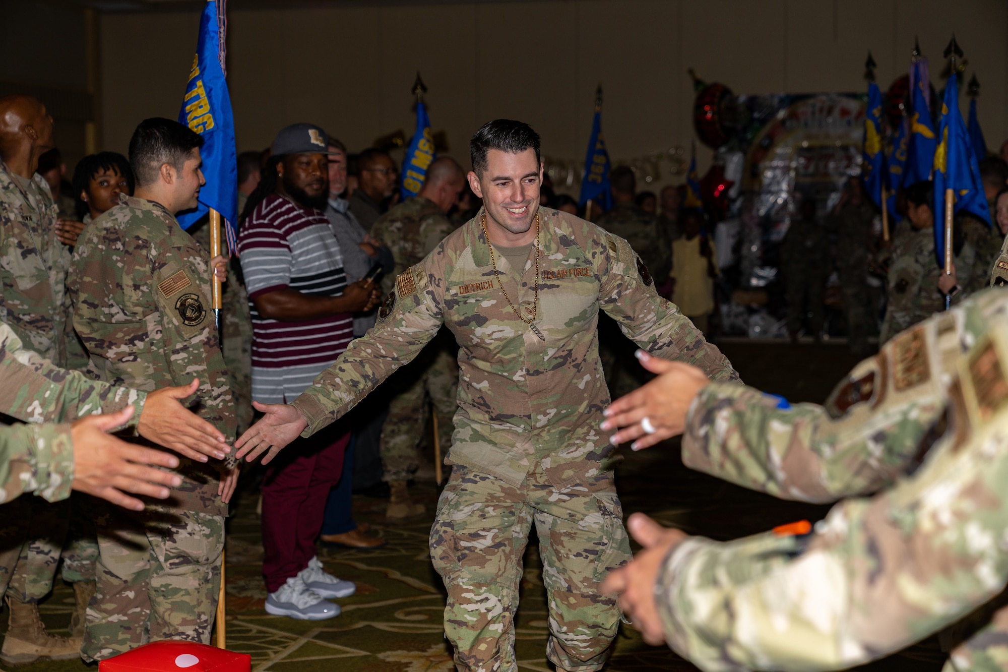 U.S. Air Force Staff Sgt. Dale Dietrich, 81st Training Support Squadron training developer, gets high fives from his peers during the Technical Sergeant Release party at Keesler Air Force Base, Mississippi, June 12, 2023.
