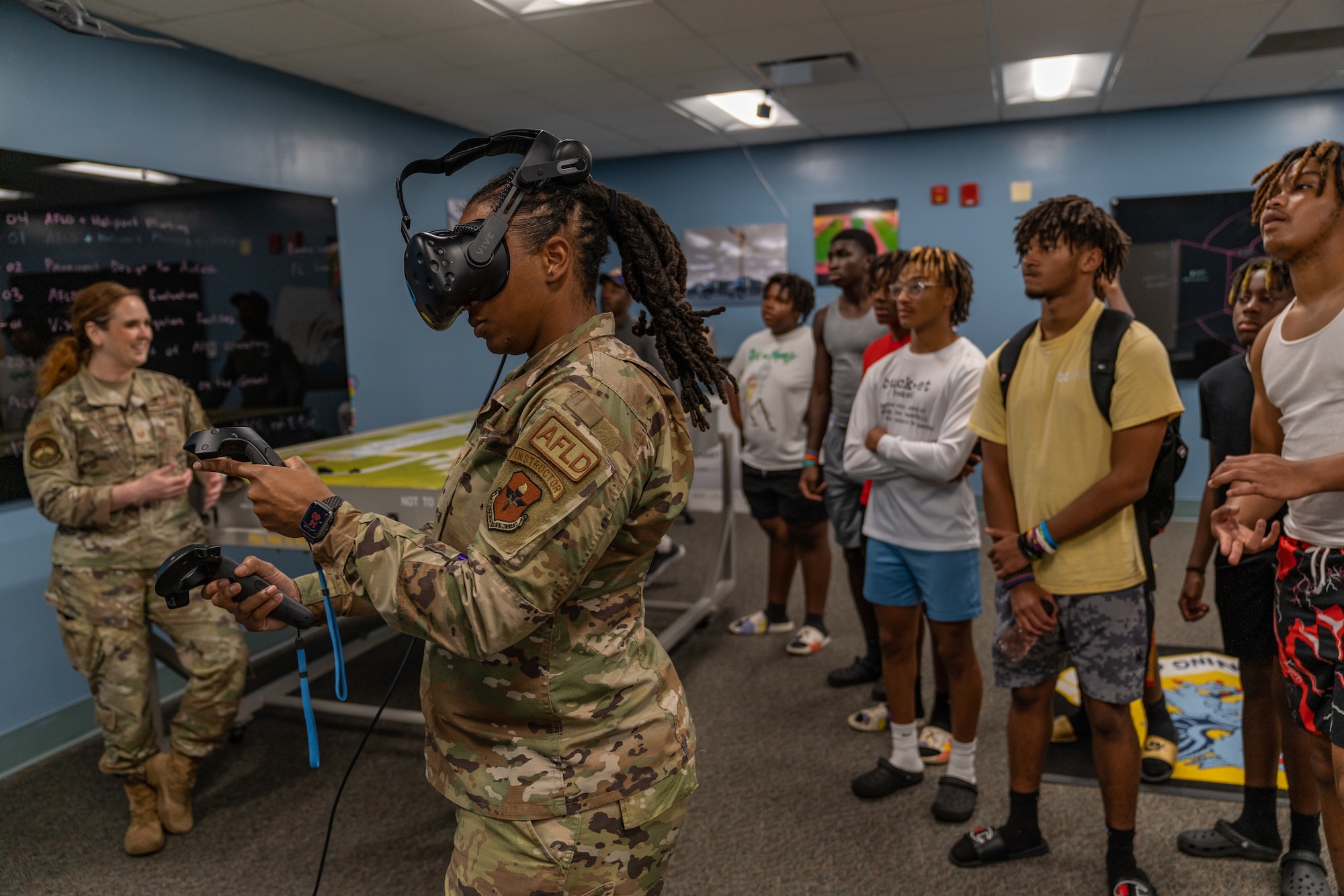 U.S. Air Force Staff Sgt. Brandie Hunt, 334th Training Squadron airfield management instructor, demonstrates VR training for Columbus High School students at Keesler Air Force Base, Mississippi, July 17, 2023.