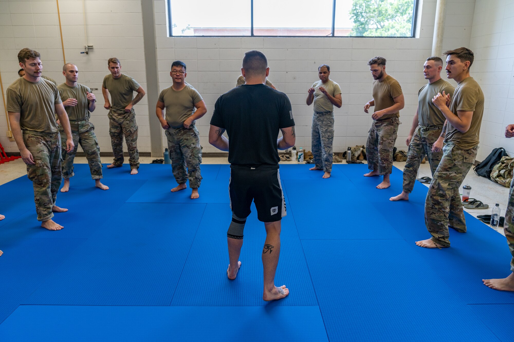 U.S. Air Force Staff Sgt. Kyle Virgillio, 5th Combat Communications Squadron master combative instructor, goes through basic movements with Airmen at the new combatives area in the 85th Engineering Installation Squadron at Keesler Air Force Base, Mississippi, July 18, 2023.