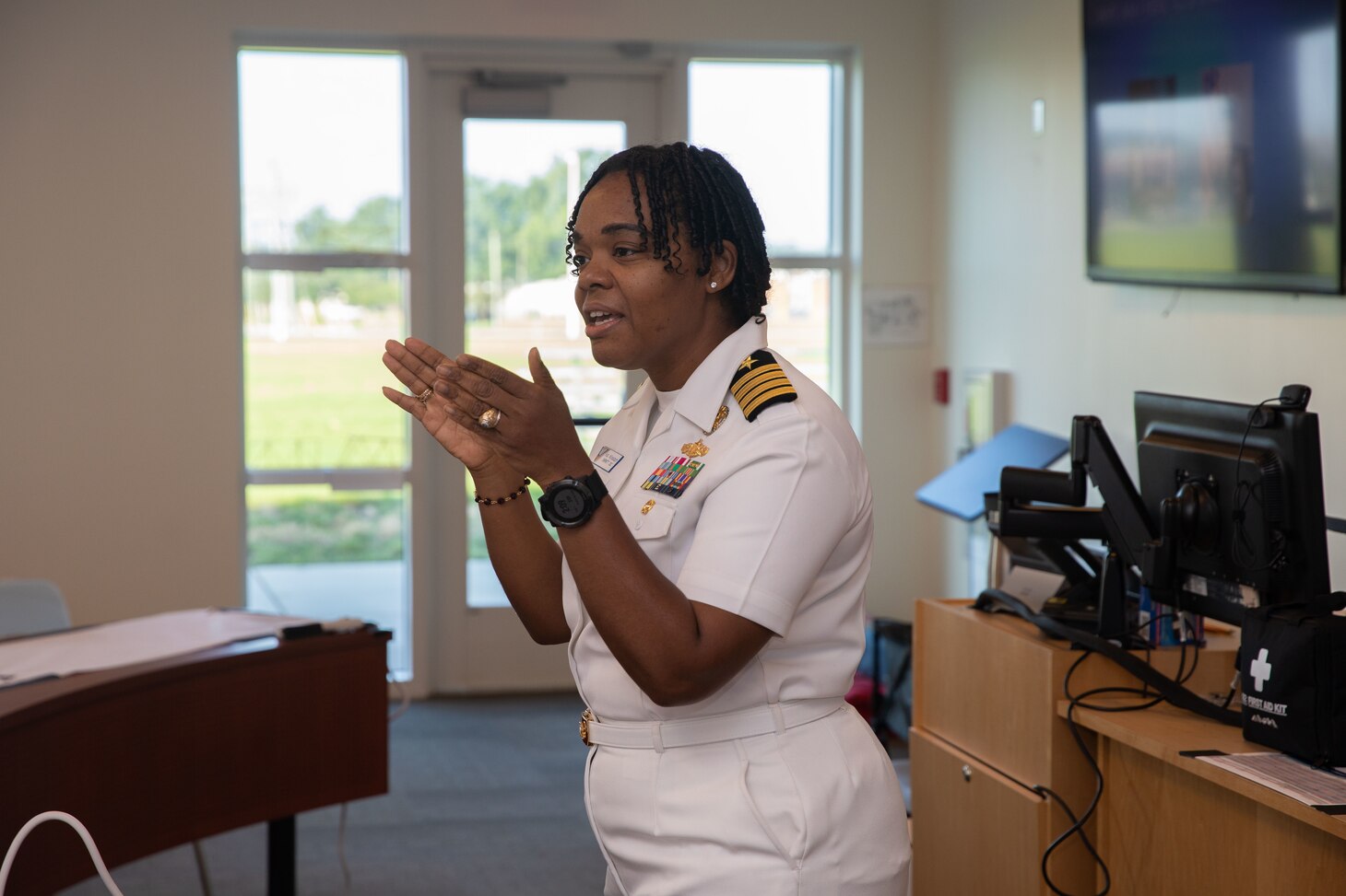 Capt. Kathryn Wijnaldum, assigned to Naval Air Force Atlantic, speaks to children.