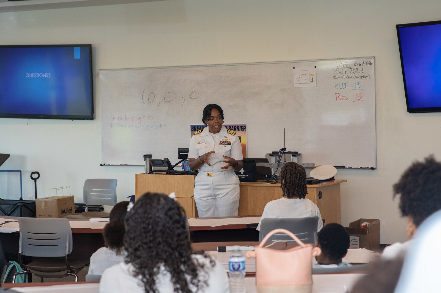 Capt. Kathryn Wijnaldum, assigned to Naval Air Force Atlantic, speaks to children.