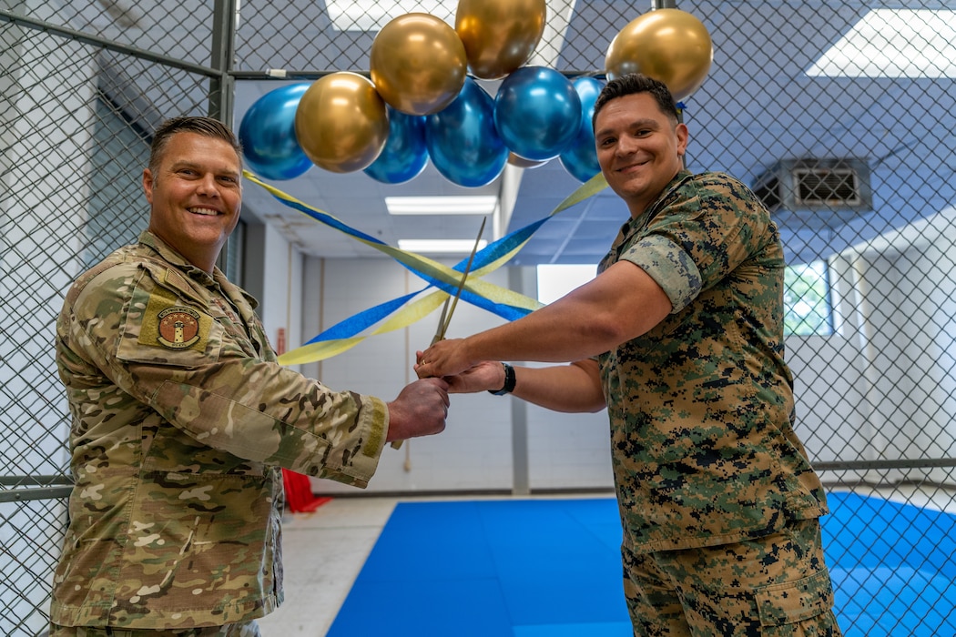 U.S. Air Force Lt. Col. Christopher Dauer, 85th Engineering Installation Squadron commander, and U.S. Marine Corps Capt. Mike Flores, Marine Detachment executive officer, cut a ribbon to officially open the new combatives area in the 85th EIS at Keesler Air Force Base, Mississippi, July 18, 2023.